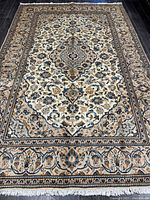 Full view of Persian Kashan rug showing entire field and borders