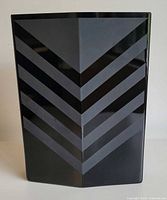 front view of black glass vase showing chevron design