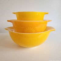 Stacked view of three yellow Pyrex bowls showing graduated sizes