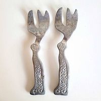 Two Don Drumm cast aluminum forks front view