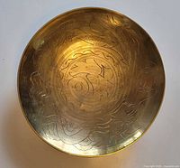 Top view of brass bowl showing complete etched dragon design