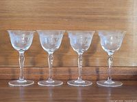 Four matching etched cordial glasses