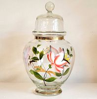 Full view of jar with lid showing floral design and gold trim
