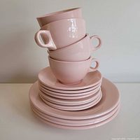 Stack of four cups on seven plates showing overall set