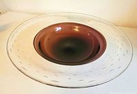 Overall profile of wide clear glass dish with amethyst centre, controlled bubbles visible