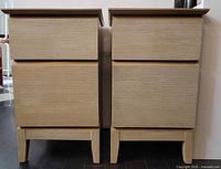 Front view of both bedside tables showing matching design and two drawers each