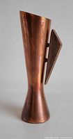 Front view of copper vase with wood accent panel