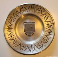 Full view of decorative pewter plate showing border pattern and central Rastatt crest
