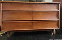 Front view showing six drawers and sculpted pulls