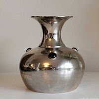 full frontal view of plated metal vase