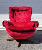 Front view showing red tufted chair and wood base