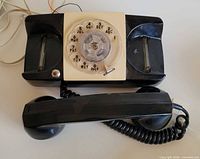 Top view showing rotary dial, base shape, handset