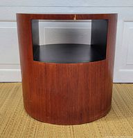 Front view of cylindrical side table with open shelf