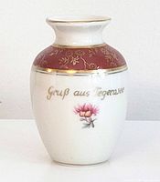 Full view of vase front showing inscription, flower motif, overall shape