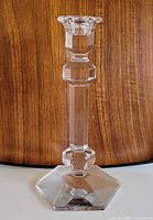 Full side view of crystal candlestick showing faceted stem and base