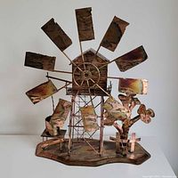 Front view of copper windmill music box sculpture