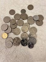 Pile of mixed Chinese coins and one copper-tone 5 Jiao