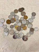 Pile of mixed Chinese coins spread on cloth
