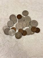 Group of approx. 27 Taiwanese coins on white towel