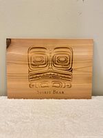 Front view of carved Spirit Bear wood plaque