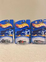 Overall view of the set of three sealed Hot Wheels cars