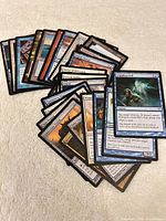 Fronts of 25 assorted Magic: The Gathering cards spread on surface