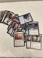 Spread of assorted Magic cards on towel surface