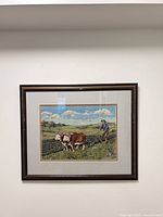 Full view of framed needlepoint art on wall