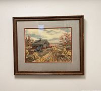 Front view of framed needlepoint homestead scene