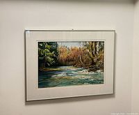 Framed painting on wall showing mat and frame