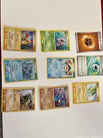 Front view of all nine Pokémon cards laid out, showing variety and condition