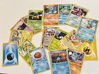Overview of all 17 cards arranged on tabletop, showing mix of creature and energy cards