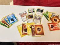 Spread of Energy and Trainer cards on table