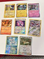 Front view of all eight Pokémon cards showing artwork, HP, and holofoil finish