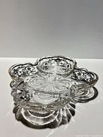 Top view showing three-section dish, silver floral overlay