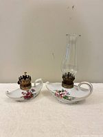 Both porcelain oil lamps side by side