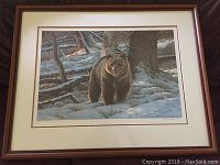 Overall view of framed print showing bear in snowy forest setting, titled and signed