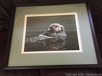 Framed print showing the sea otter artwork from a top view.