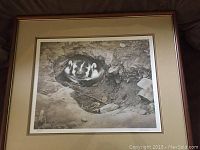 Framed print showing badger curled in den, overall view of artwork and frame