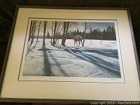 Framed art print showing mule deer and snowy forest landscape with shadows cast by trees.