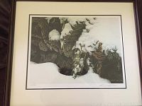Framed print showing winter scene with a bird perched on branches, snow covered. Includes frame and white matting.