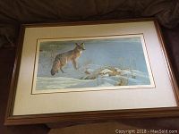 Full frontal view of framed print on floor showing frame and mat