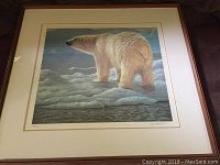 Framed print showing full artwork of polar bear on ice with signature and numbering visible below.
