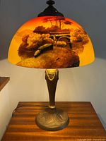 Lamp lit showing landscape scene with bridge on shade