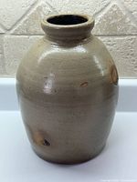 Full view of stoneware crock showing overall shape and glaze