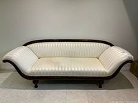Front view of cream striped damask Regency style sofa showing entire frame and upholstery