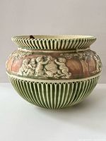 Front view of Roseville Donatello jardiniere showing ribbed lower section and cherub relief band