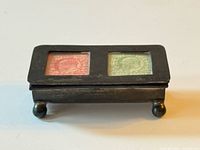 Top view showing two stamp windows with red and green stamps, full box visible