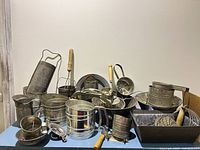Full view of assorted tin kitchenware displayed on surface
