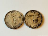 Front view of both Centennial silver dollars showing goose design and date
